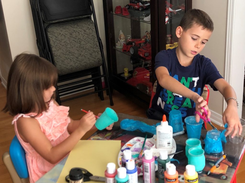 Adriana and Christian painting and making teal light crafts