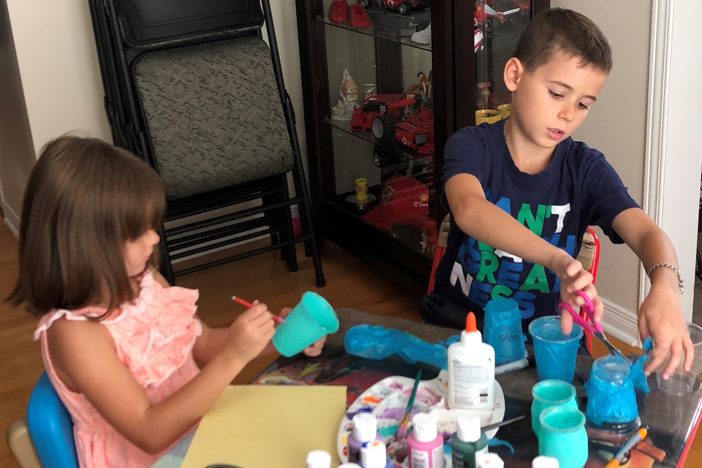 Adriana and Christian D. painting and making teal light crafts