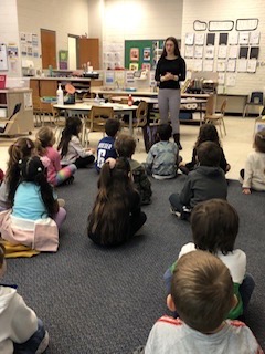 Aliya presenting to students at her elementary school