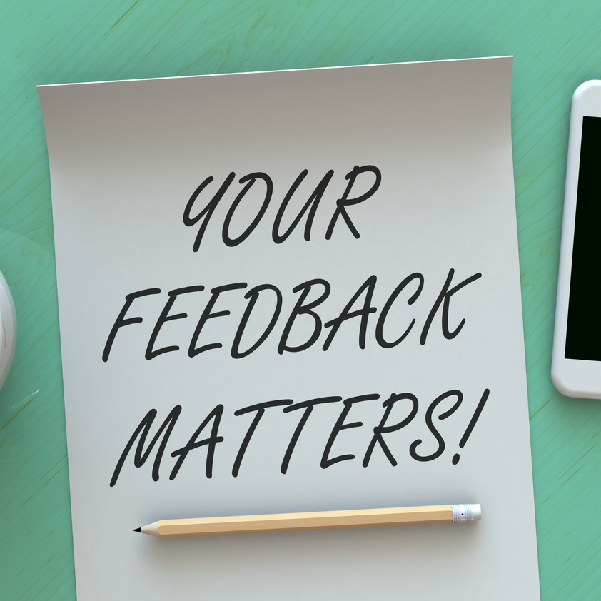 Your Feedback Matters, message on paper, smart phone and coffee on table