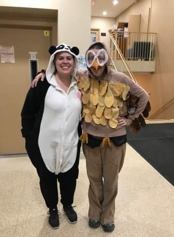 Janice dressed up in an owl costume next to a friend, who is dressed up in a panda costume
