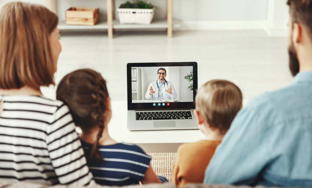 Family conducts a video conference video chat consultation with a doctor online sitting at home