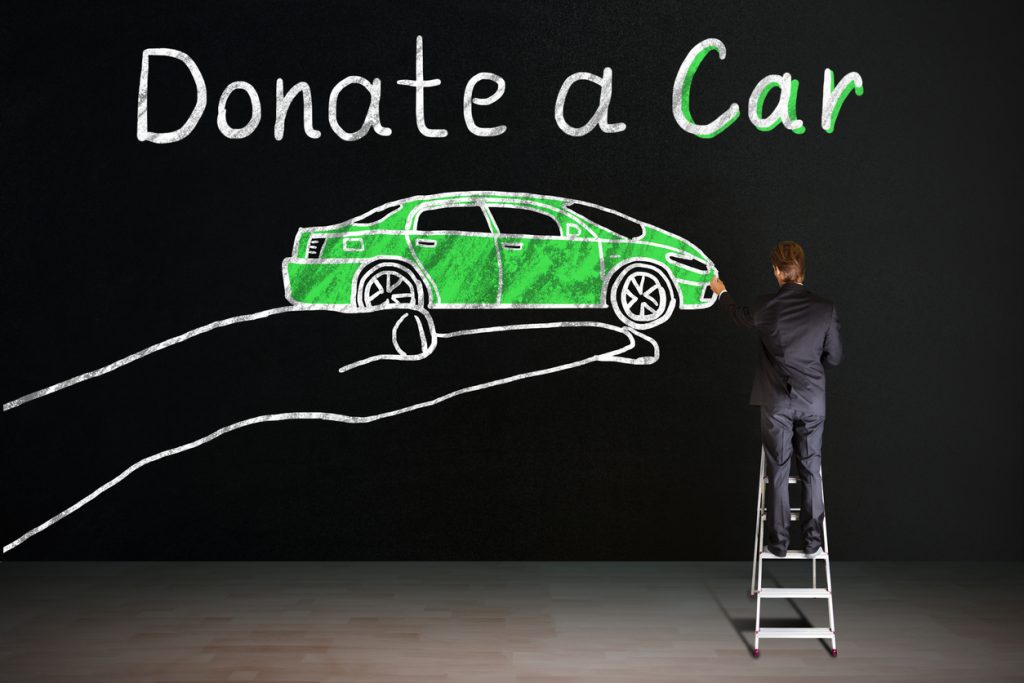 Donate a car written on Blackboard With Chalk