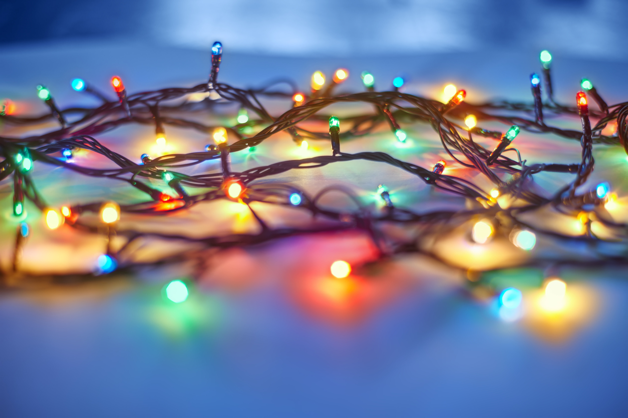Christmas lights on dark blue background. Decorative garland
