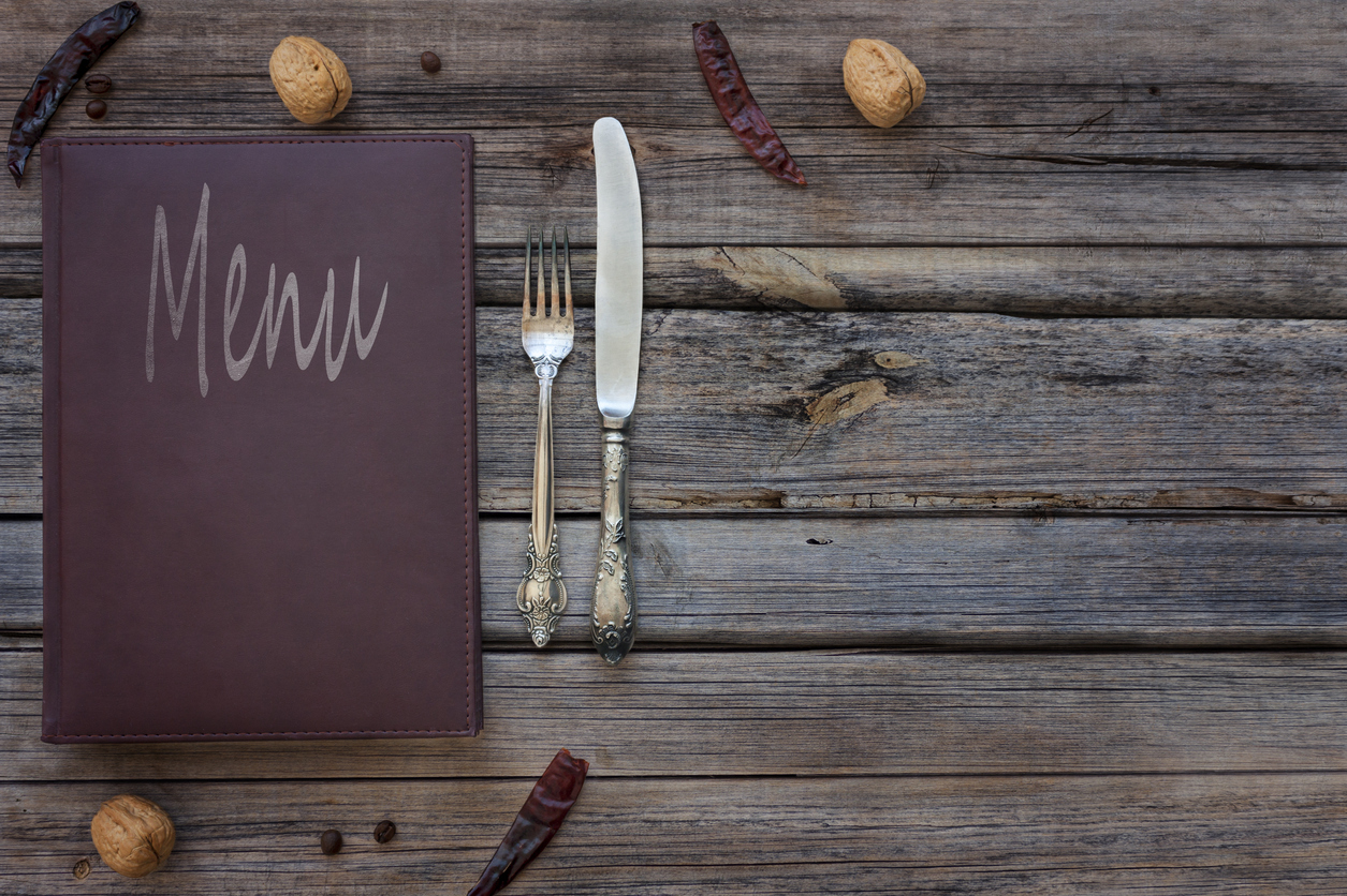 View of a vintage restaurant menu on a rustic wood background