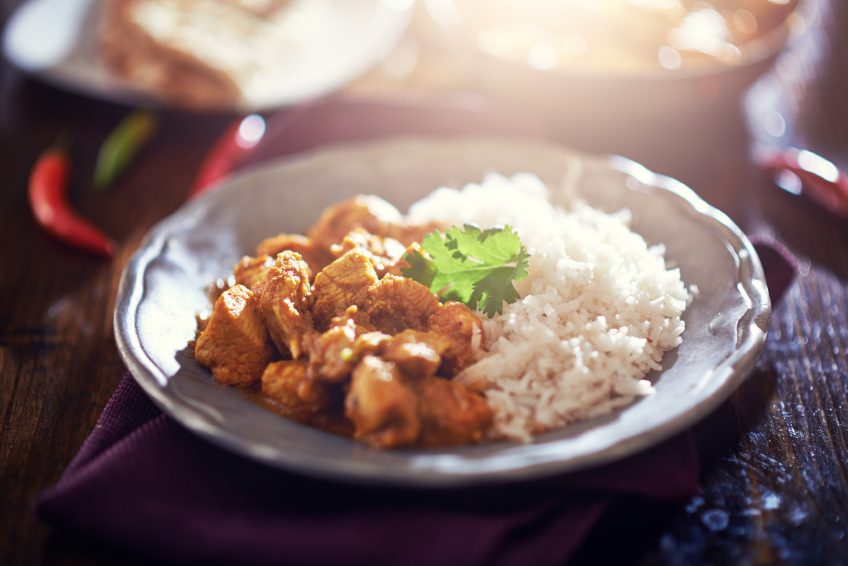 toned image of indian chicken curry with basmati rice