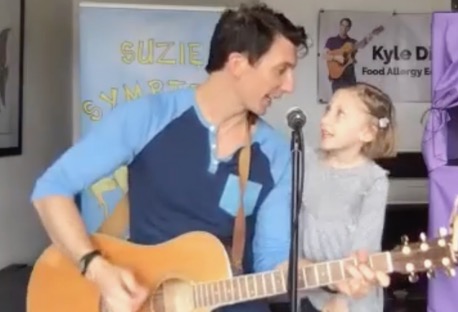 Kyle Dine performing with his daughter Zora