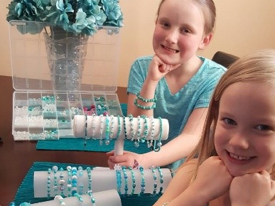Danica and Delaney pose with their teal bracelets