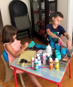 Christian and Adriana Di Criscio from Montreal create teal lantern crafts for Halloween.