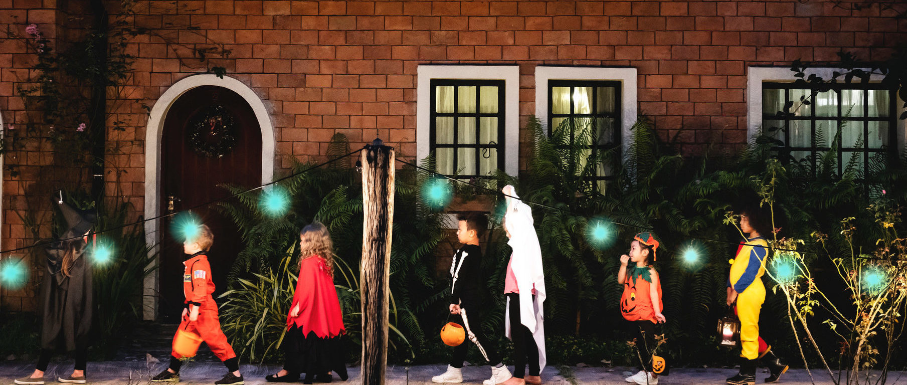 Children trick-or-treating while keeping social distance