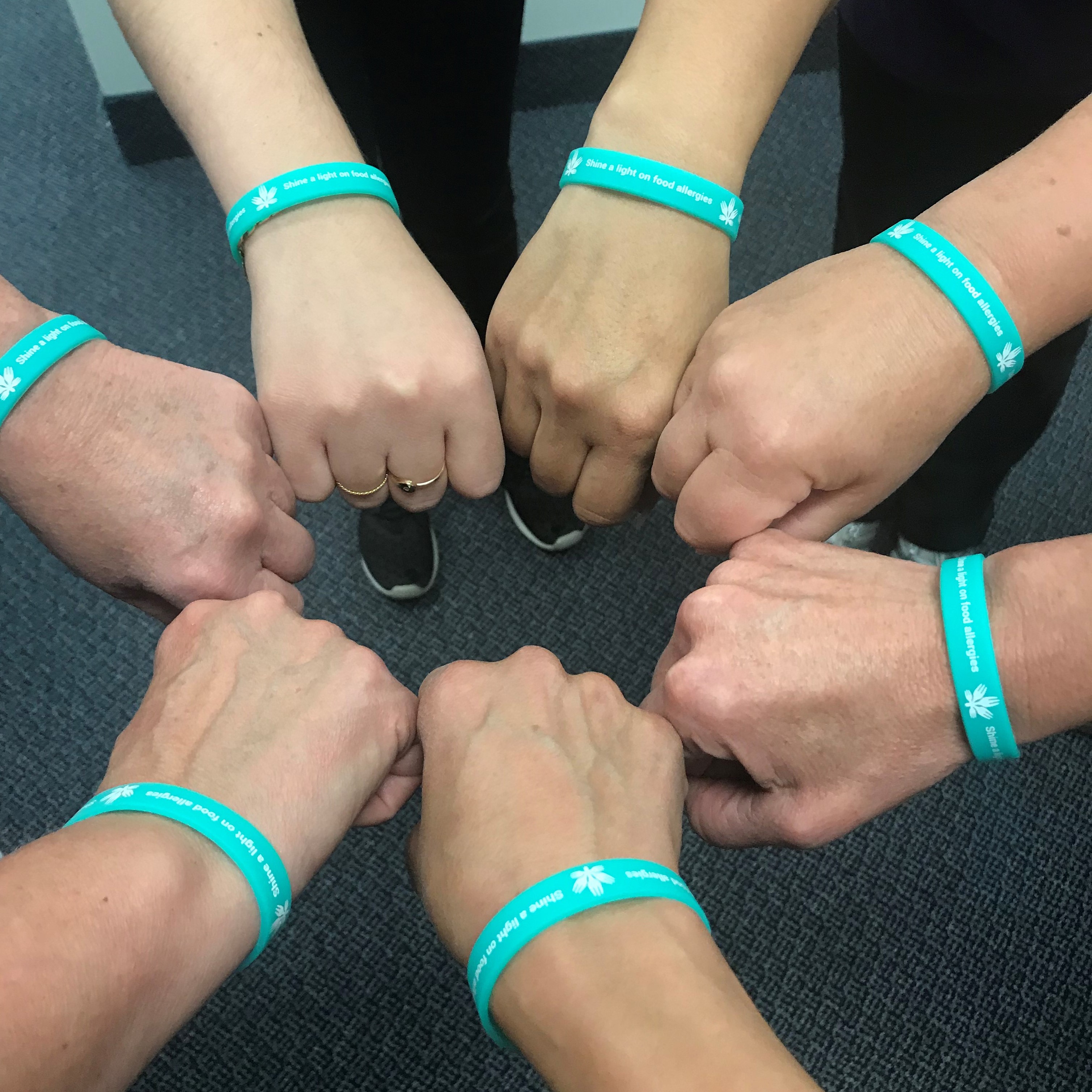 Food Allergy Canada team with team wearing teal shine a light bracelets