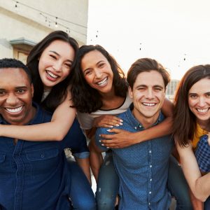 Group of adults hugging and smiling