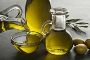 Olive oil pouring in to glass bowl