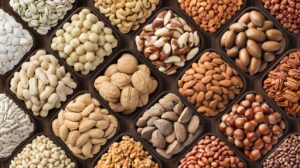 assorted nuts background, large mix seeds. raw food products: pecan, hazelnuts, walnuts, pistachios, almonds, macadamia, cashew, peanut and other