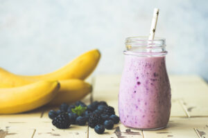 Purple blueberry blackberry and banana smoothie in a jar. Toned image. Healthy beverage or vegan vegetarian food