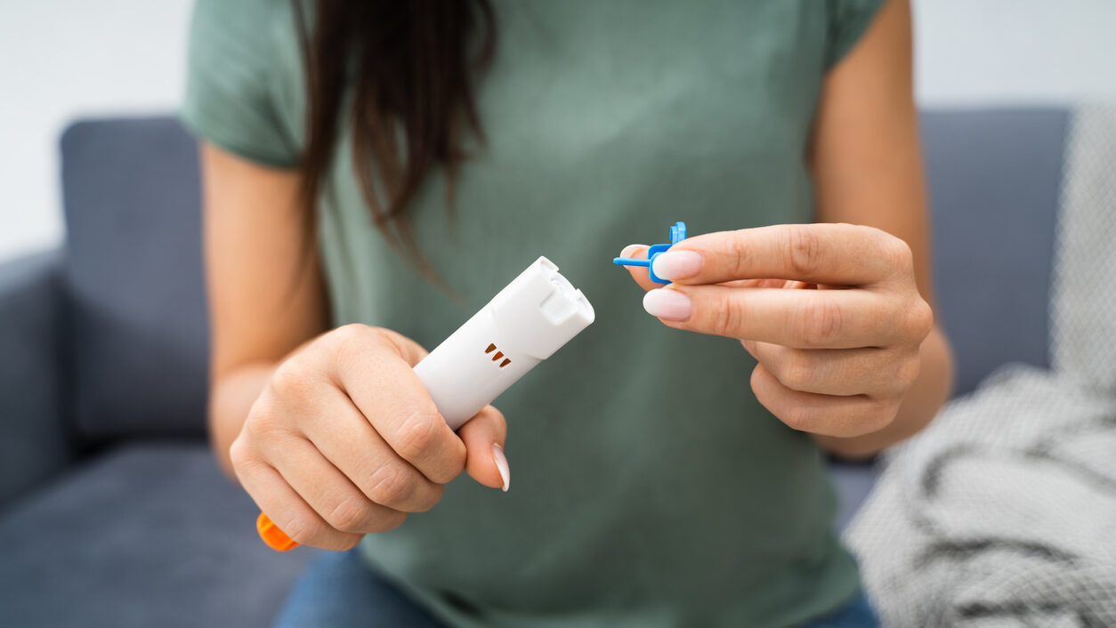 Woman Using Auto-injector As An Emergency Treatment For Allergic Reaction