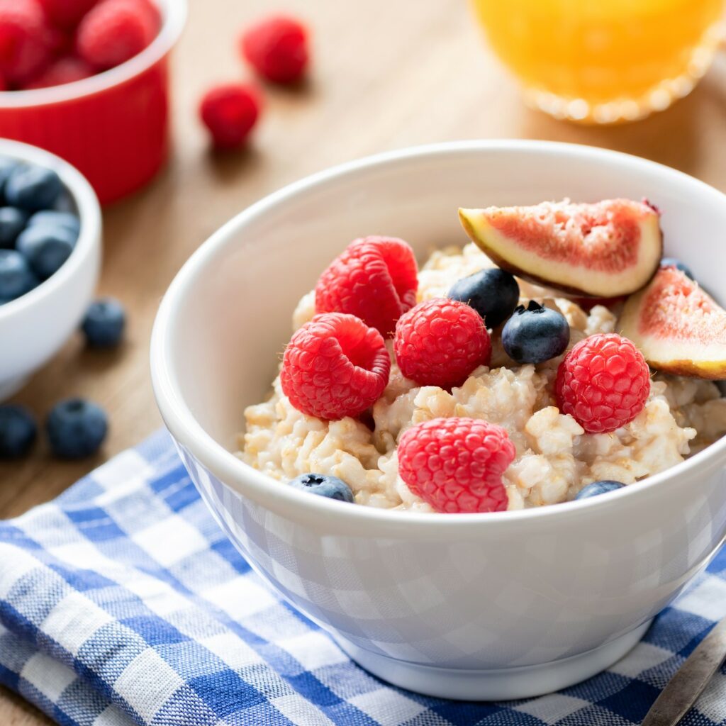 Tasty oatmeal with berries and fruits in a bowl. Healthy breakfast food concept