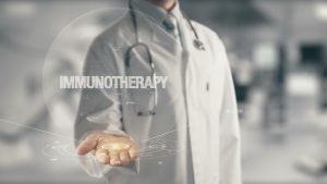 Doctor holding in hand word Immunotherapy