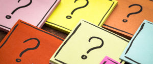 Question marks written on different coloured papers